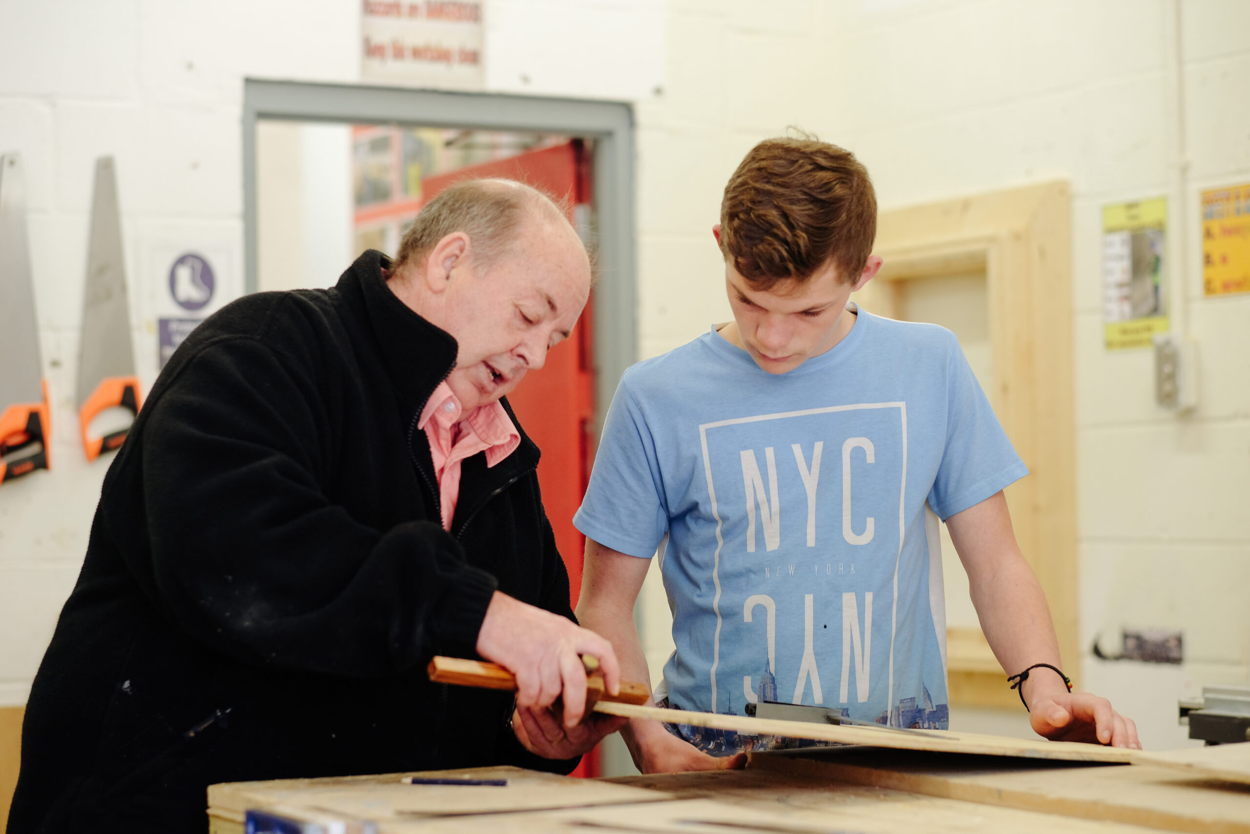 Woodwork learner with tutor in a workshop