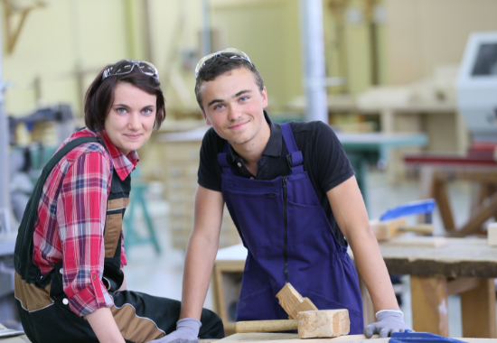 2 woodwork learners smiling