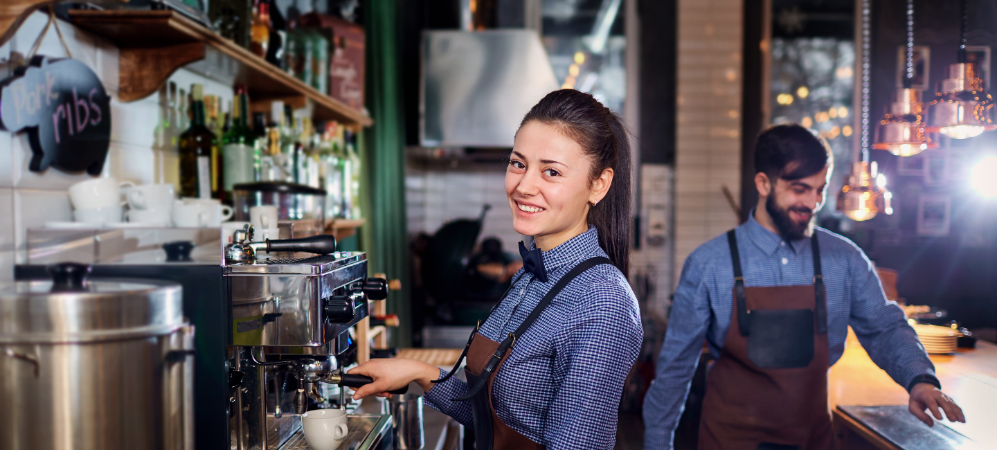 2 hospitality workers working at a cafe